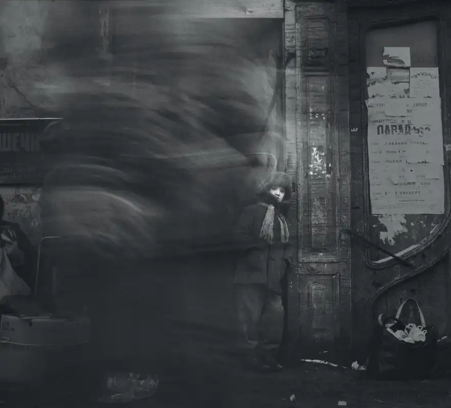 A boy stands still against a worn Saint Petersburg wall while a passing crowd becomes a dark blur.