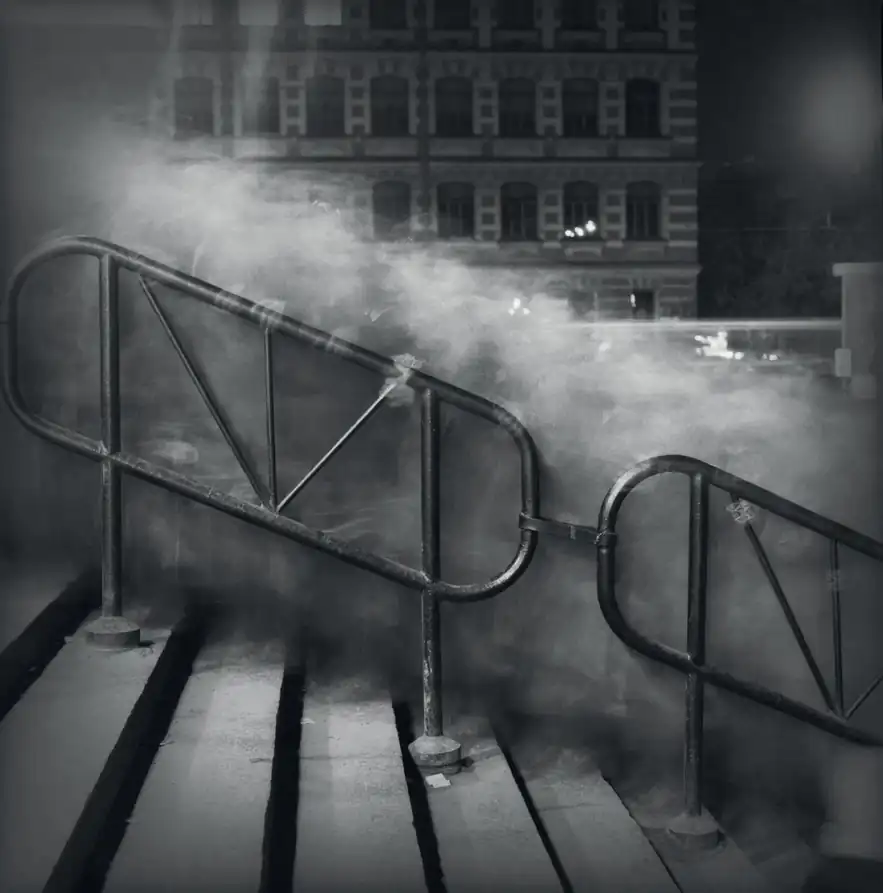 A long-exposure crowd flows like mist around the railings of Vasileostrovskaya Metro Station in Saint Petersburg.