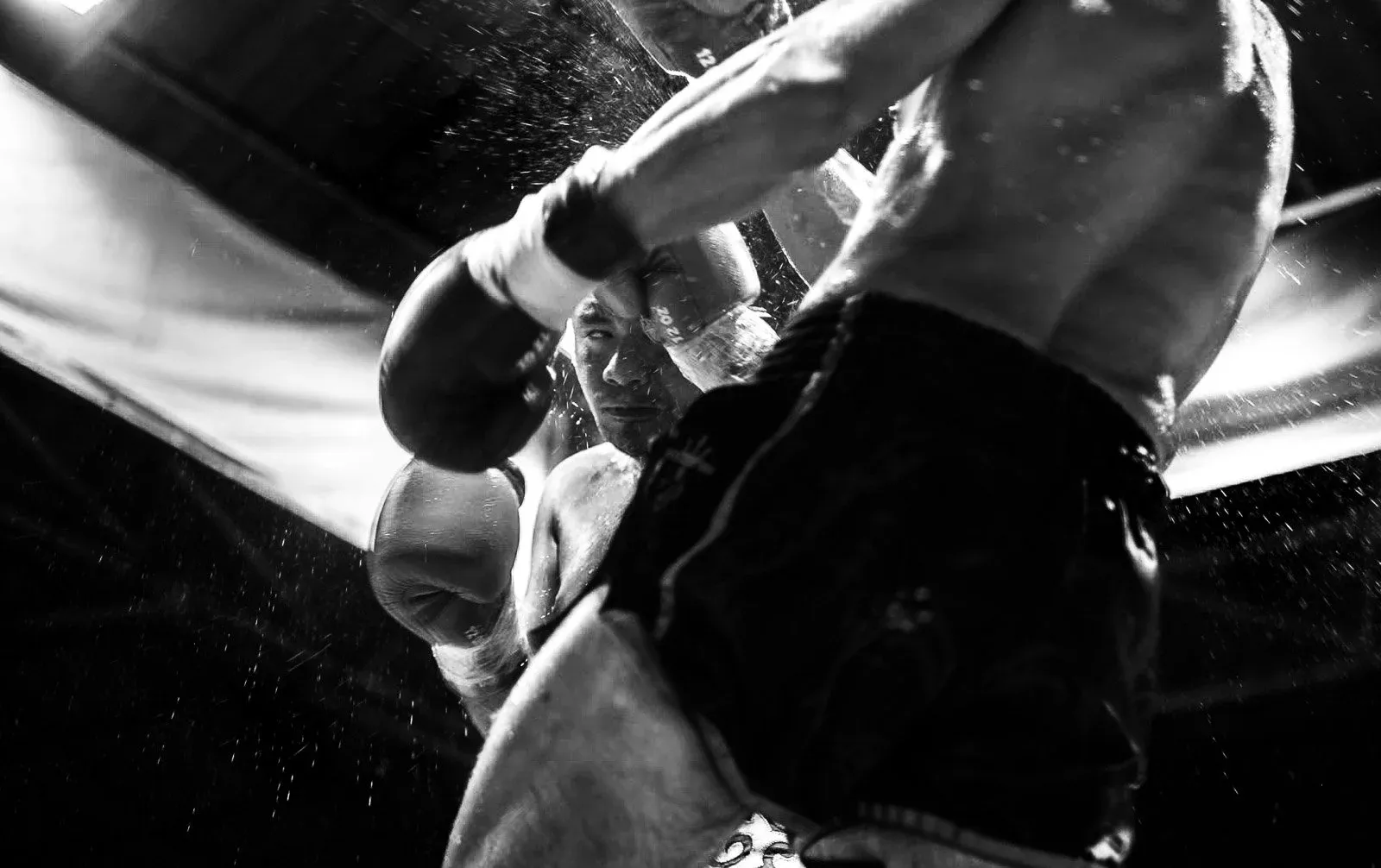 Two Muay Thai fighters exchange strikes at close range