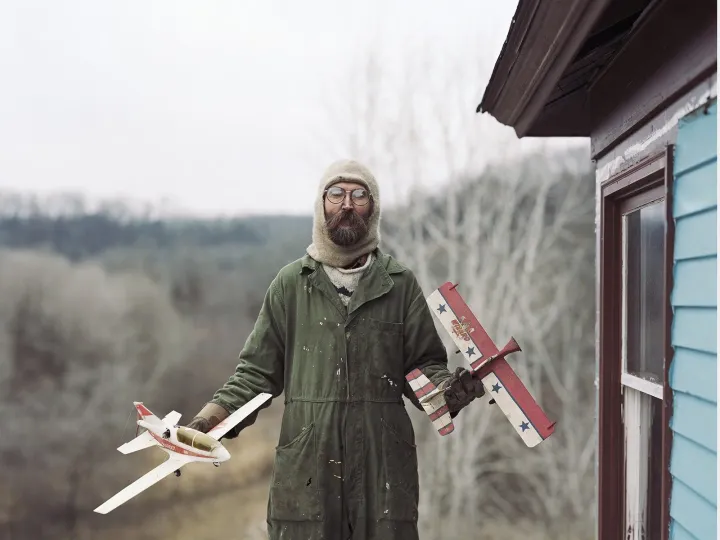 Alec Soth holding model airplanes outdoors