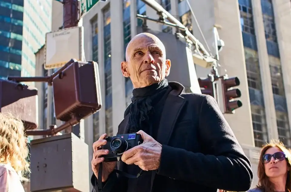 Joel Meyerowitz holding a camera on a New York City street