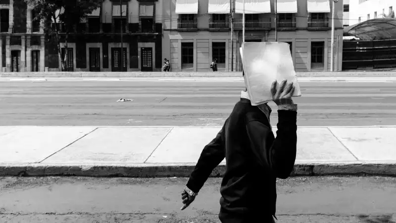 Man covering his face on a Mexico City street
