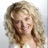 Underexposed community photographer with curly blonde hair